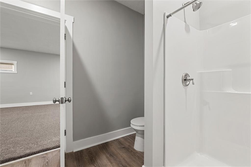 309 Beech Street Vandergrift, PA 15690 - Photo 40 of 47 a bathroom with a granite countertop shower and a toilet