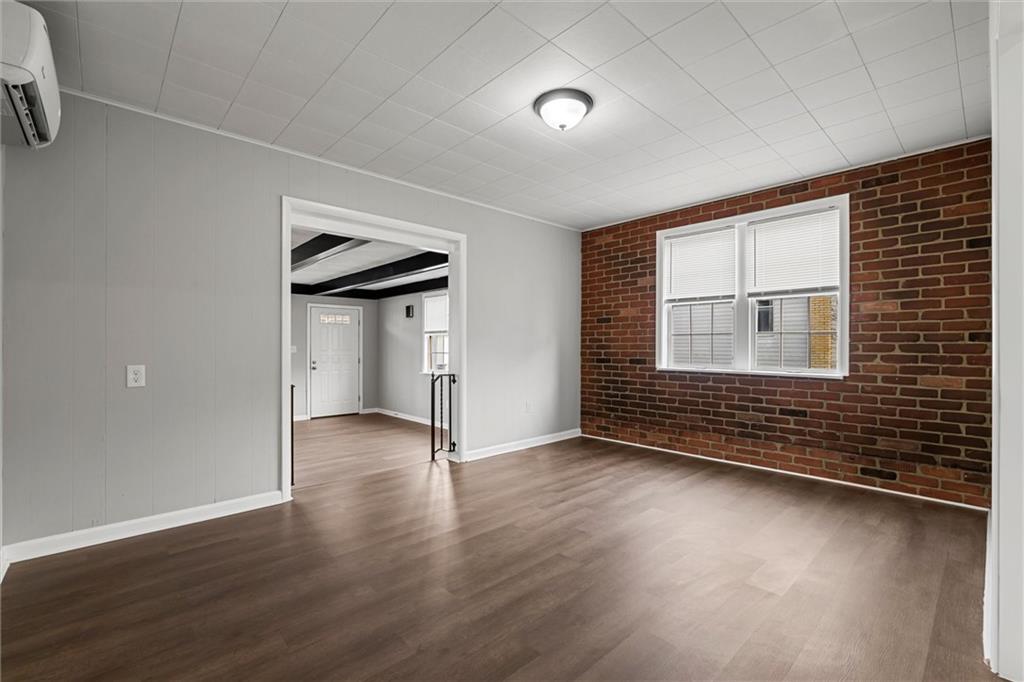 309 Beech Street Vandergrift, PA 15690 - Photo 7 of 47 an empty room with wooden floor and windows