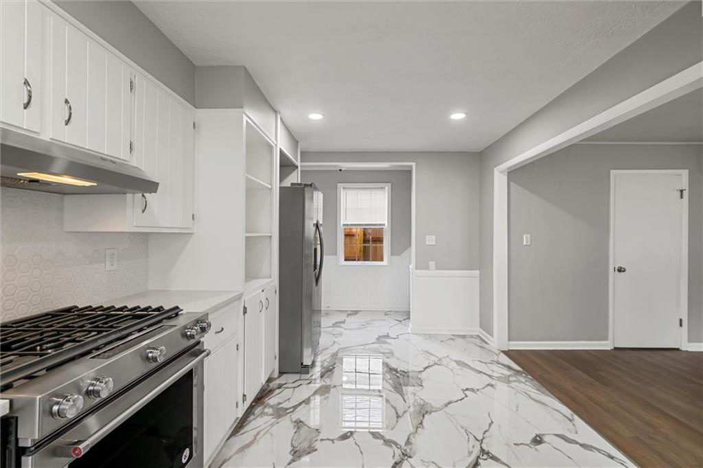 309 Beech Street Vandergrift, PA 15690 - Photo 10 of 47 a kitchen with stainless steel appliances granite countertop a stove and a refrigerator
