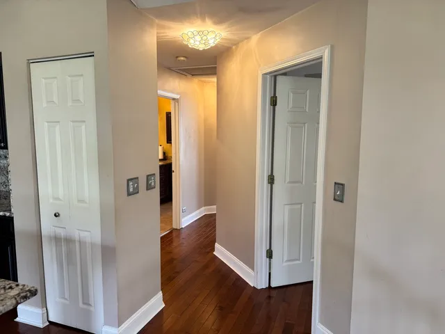 a view of a hallway with wooden floor