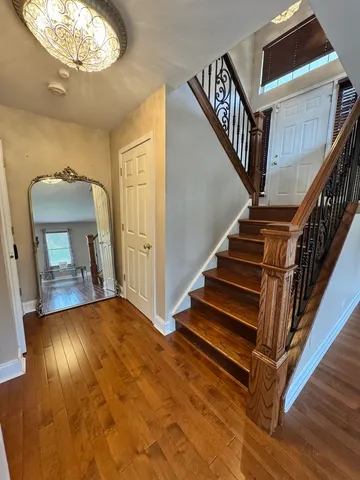 a view of entryway and hall with wooden floor