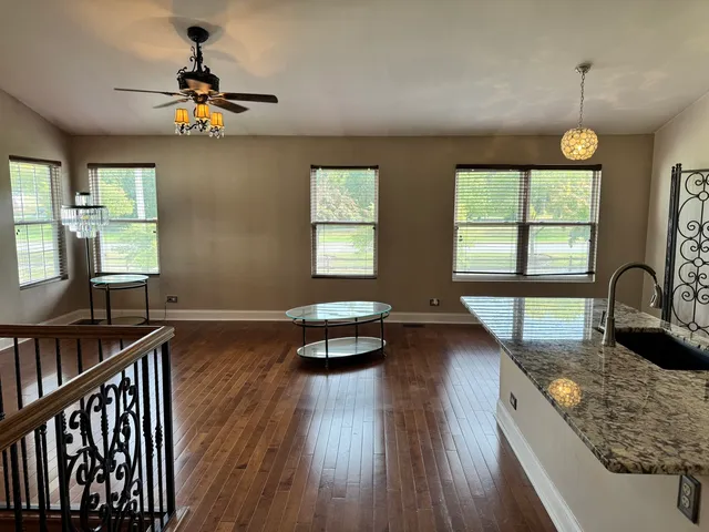 a view of a livingroom with furniture window and wooden floor