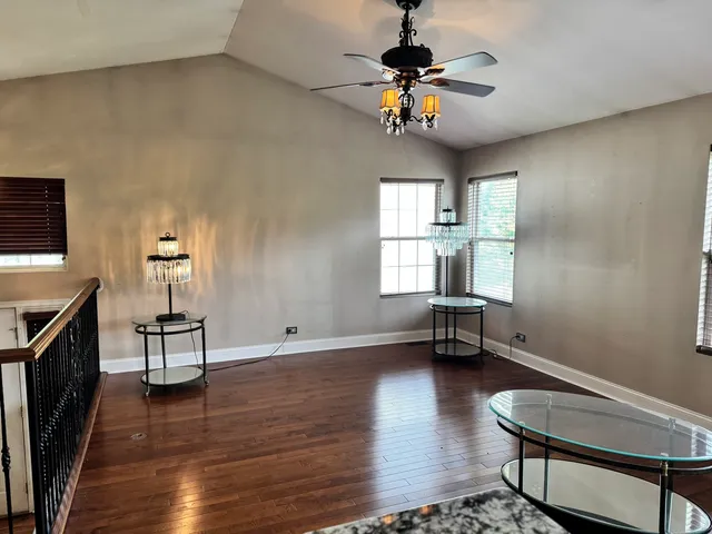 a view of a livingroom with furniture hardwood floor and a window