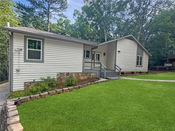 a front view of house with yard and green space