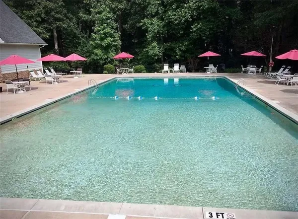 an outdoor space with swimming pool and furniture