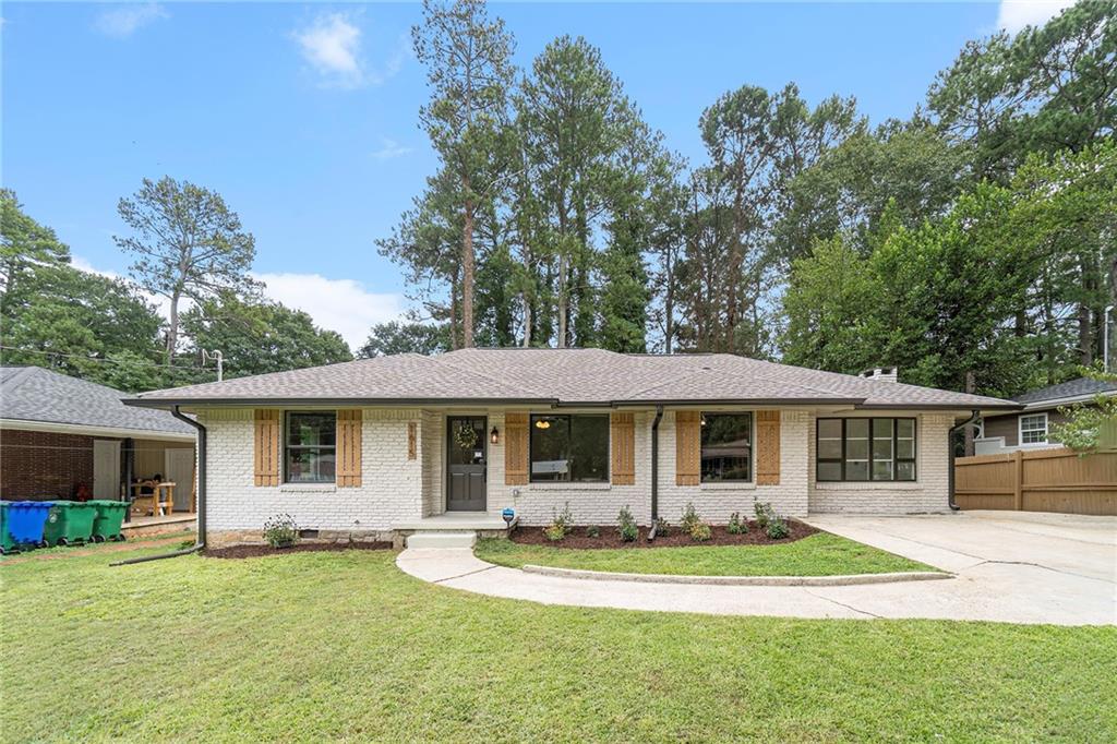 1615 Tanager Circle Decatur, GA 30032 - Photo 1 of 1 a front view of a house with a yard table and chairs