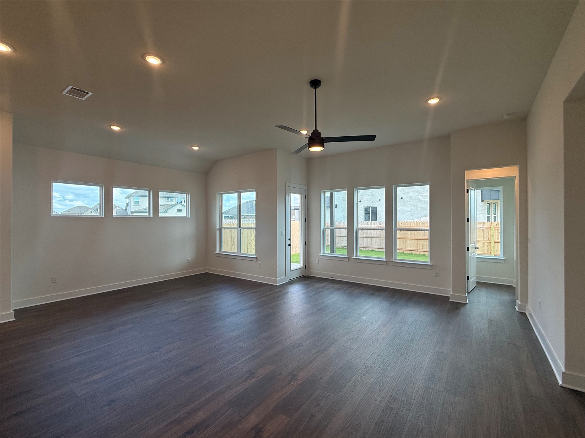17336 Graces Path Pflugerville, TX 78660 - Photo 4 of 11 a view of an empty room with wooden floor and a window