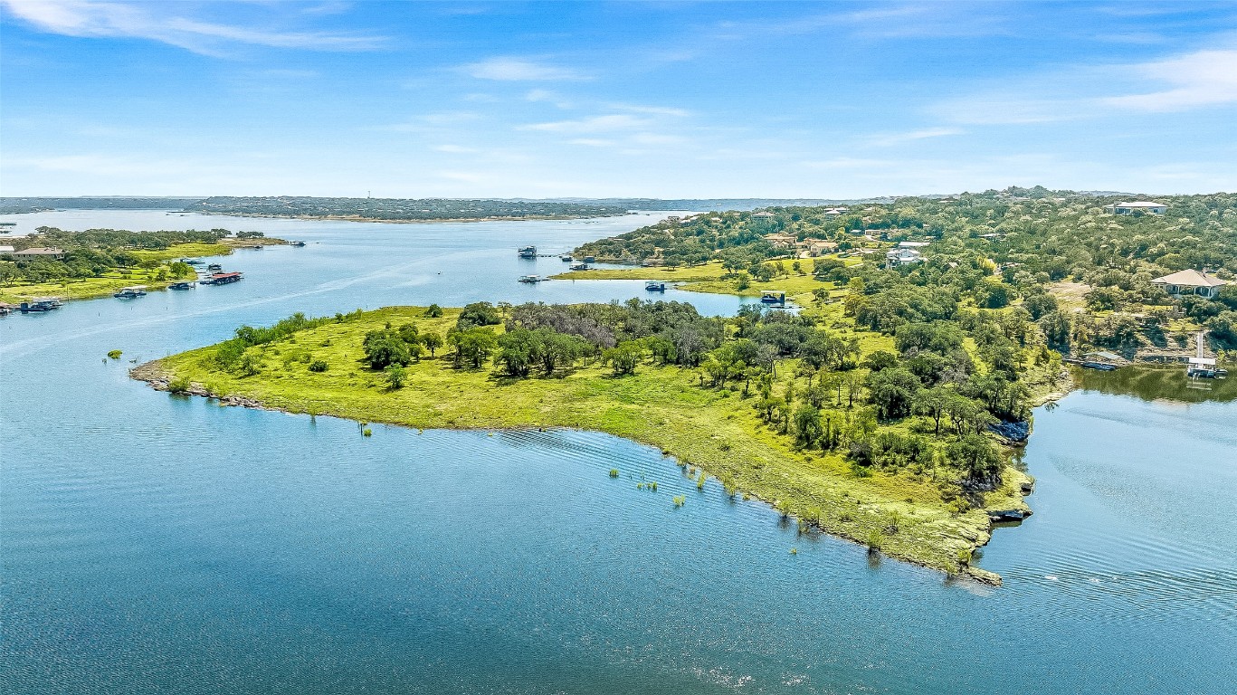 19815 Lakehurst Loop Spicewood, TX 78669 - Photo 8 of 21 a view of a lake with a beach