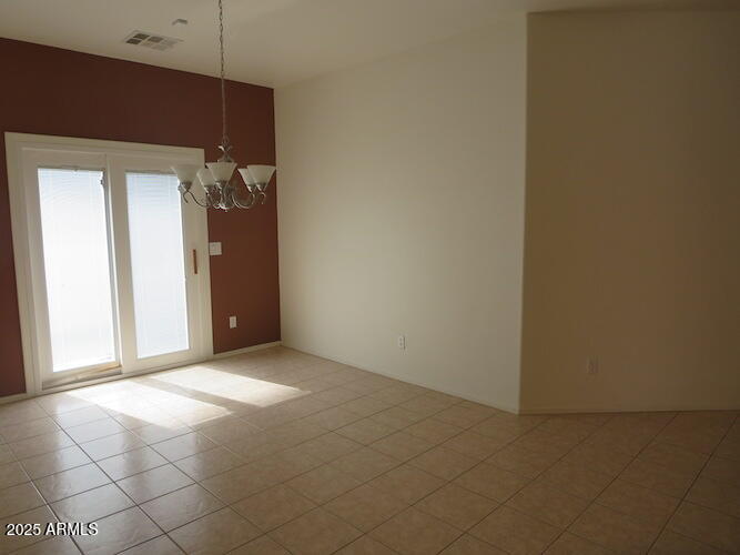7120 South 68th Avenue Laveen, AZ 85339 - Photo 7 of 17 an empty room with windows and entrance