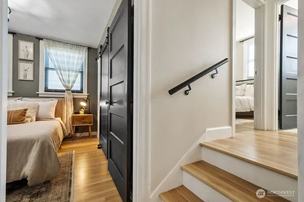 a bedroom with a bed and a large window