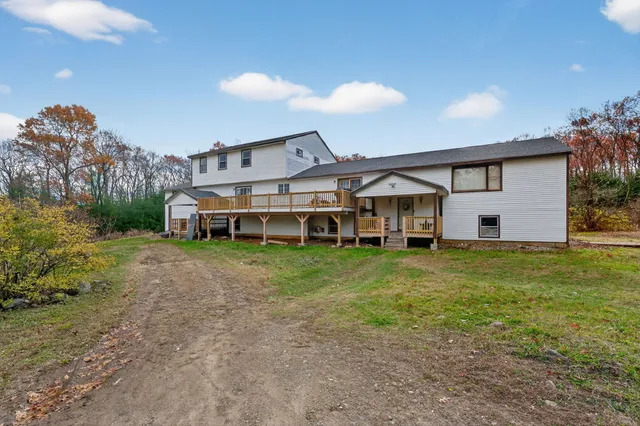 a front view of a house with a garden