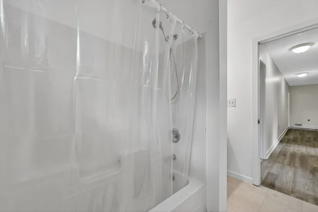 a bathroom with a shower and a tub