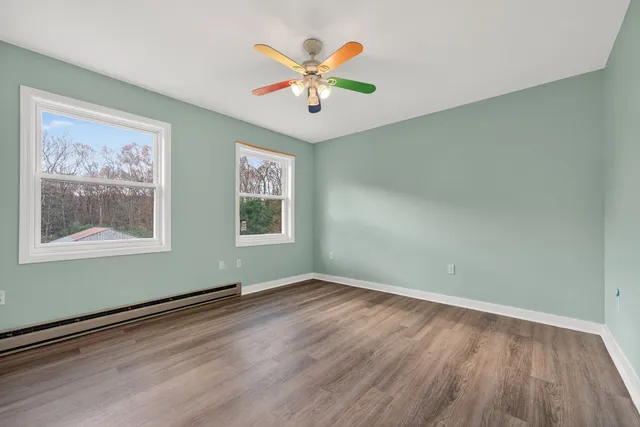 wooden floor in an empty room with a window