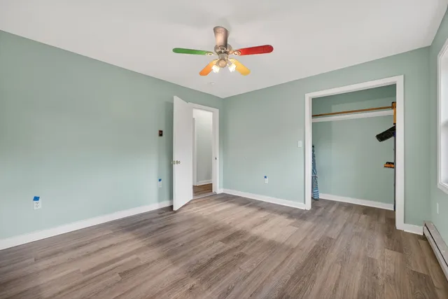 a view of an empty room with wooden floor