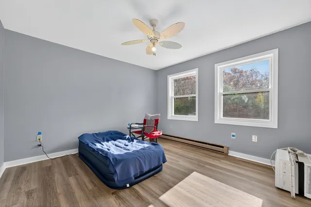 a living room with furniture chandelier and a window