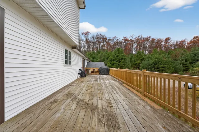 a view of a balcony with wooden floor and fence