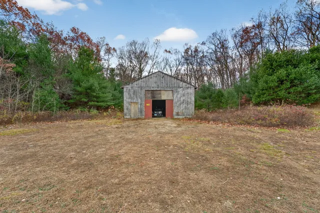 a view of a big house with large trees and plants