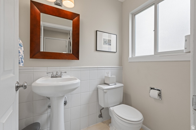 3320 Cherokee Lane Provo, UT 84604 - Photo 18 of 52 Bathroom with a white pedestal sink, chrome faucet, and a wood-framed mirror