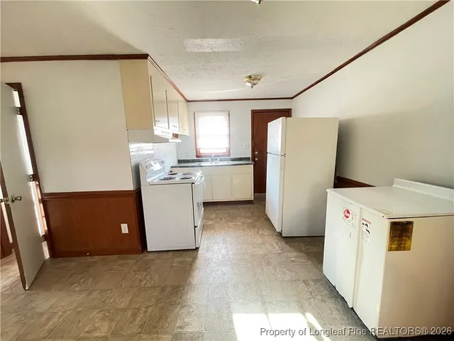 a kitchen with a refrigerator a stove top oven a sink and dishwasher