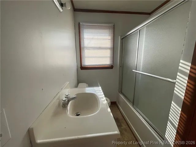 a bathroom with a sink and shower