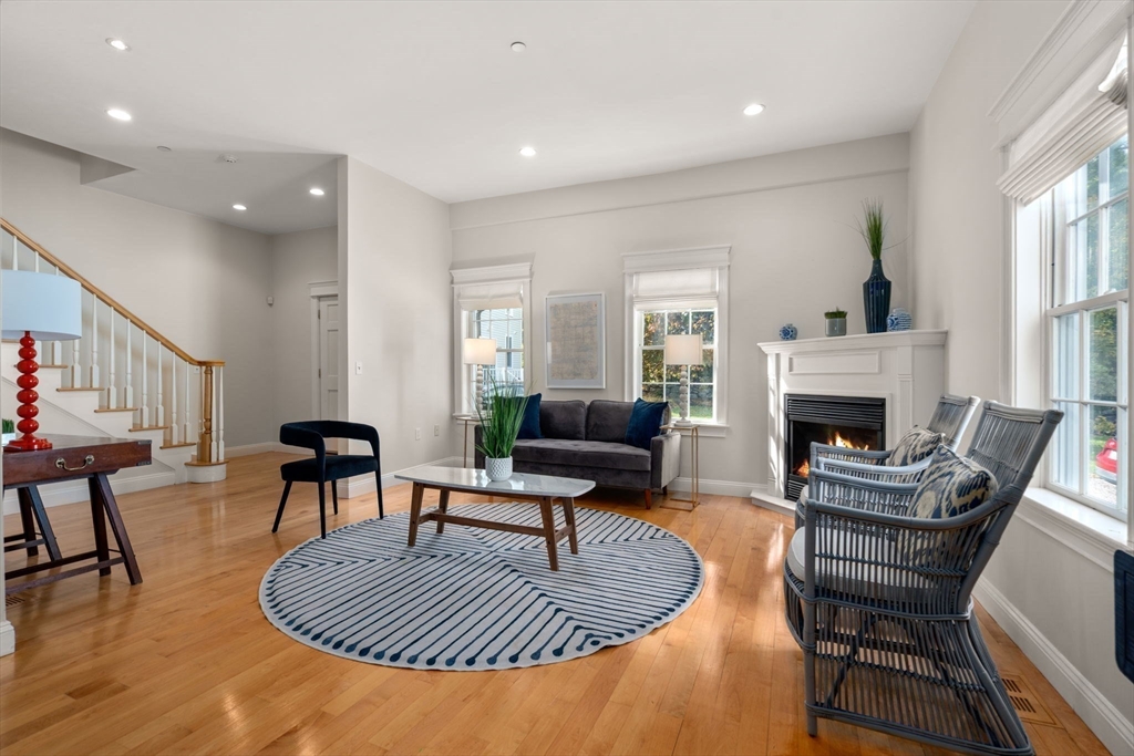 809 Boston Post Road, Unit B Weston, MA 02493 - Photo 7 of 39 a living room with furniture a fireplace a rug and a window