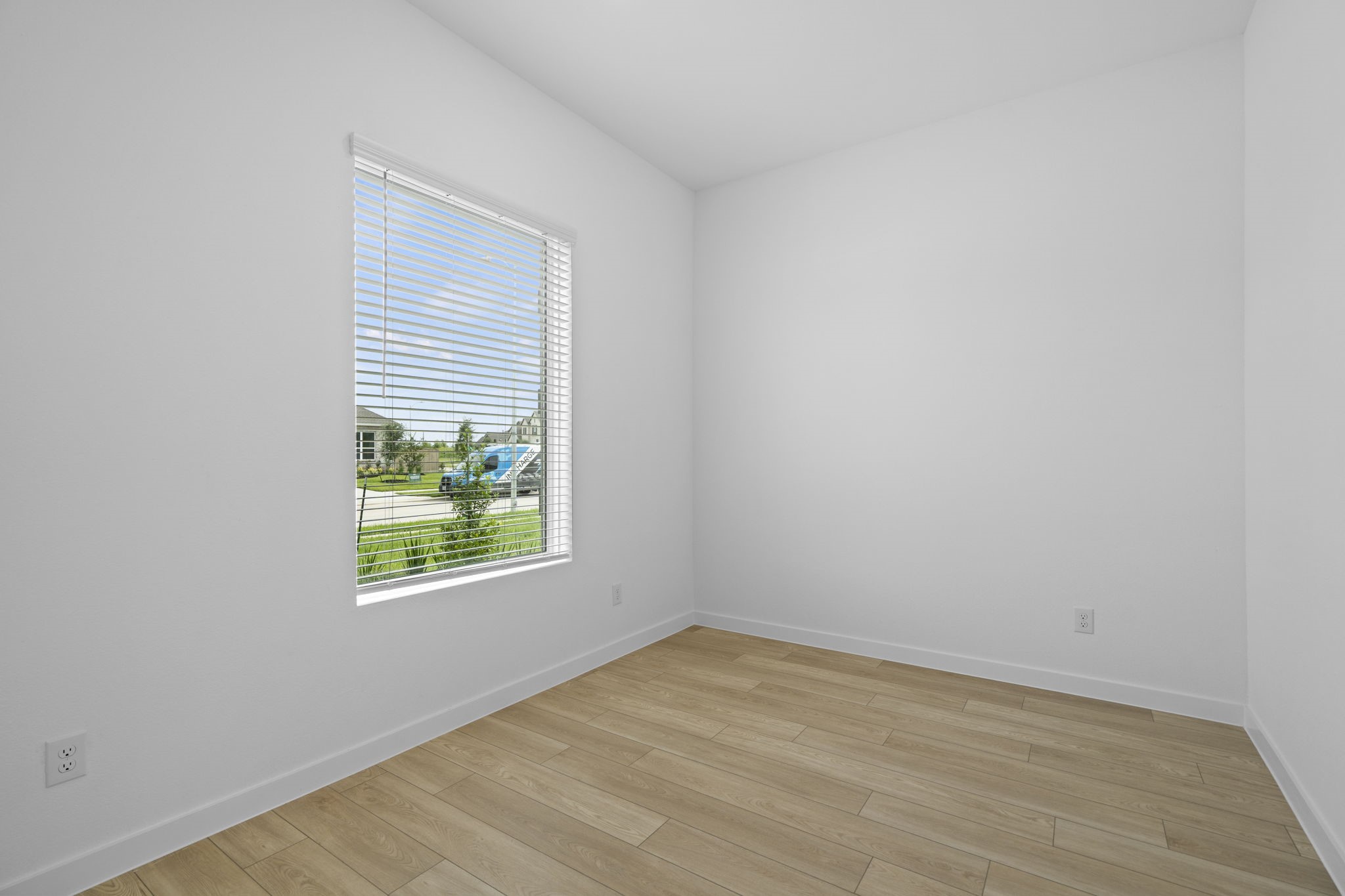 2720 Grove Crest Drive Rosenberg, TX 77469 - Photo 7 of 32 Bright flex space/Home Office with wood-look flooring, clean lines, and a large window that fills the room with natural light.