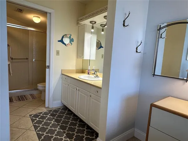 a bathroom with a double vanity sink mirror and toilet