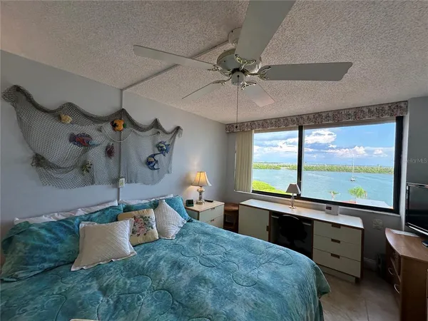 a bedroom with a large bed and a large window