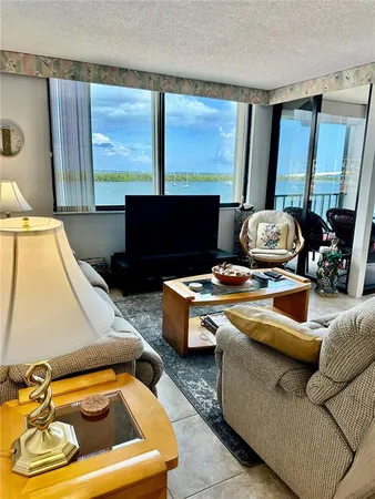 a living room with a couch and large windows