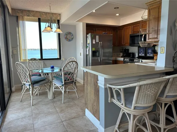 a view of a dining room with furniture and a chandelier