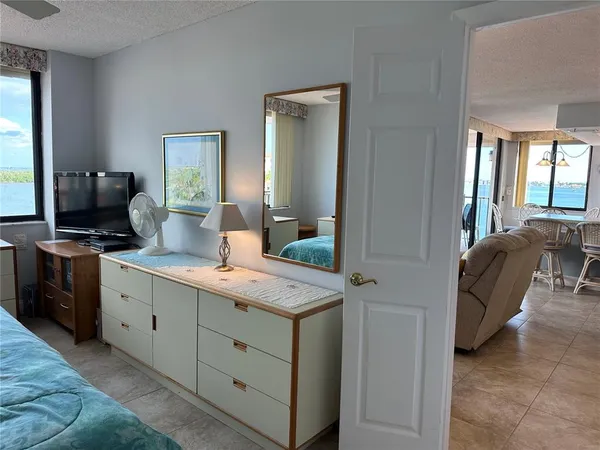 a en suite bathroom with a granite countertop sink and a mirror
