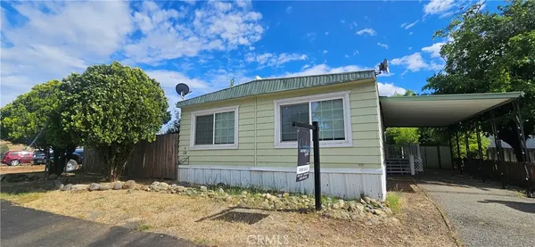 a view of a house with a tree in the background