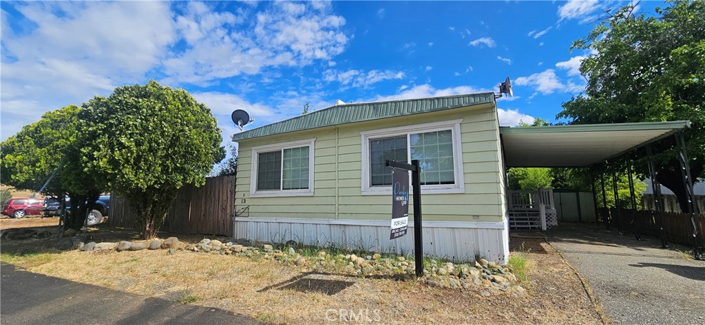 2920 Clark Road, Unit C12 Oroville, CA 95965 - Photo 1 of 17 a view of a house with a tree in the background