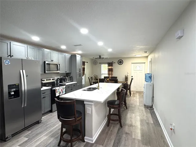 a large kitchen with a table and chairs