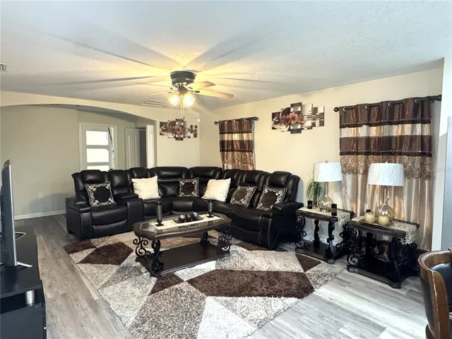 a living room with furniture and a chandelier