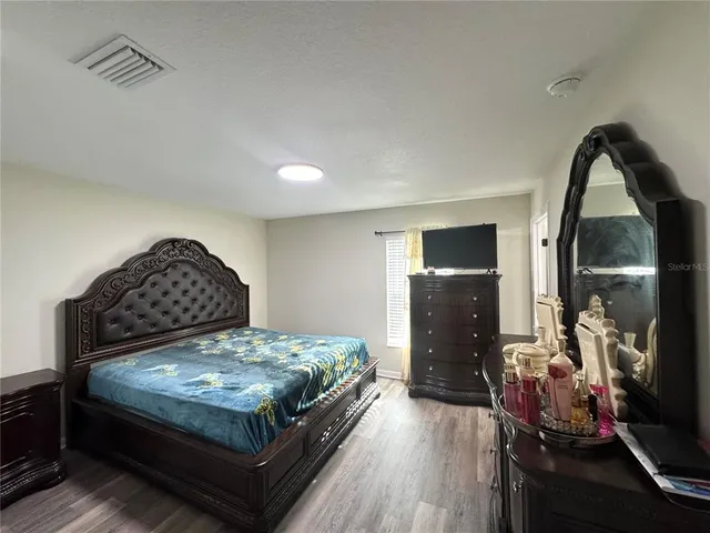 a bedroom with a bed and dresser