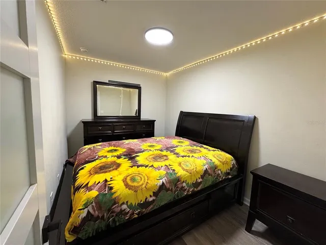 a bed sitting in a bedroom next to a window