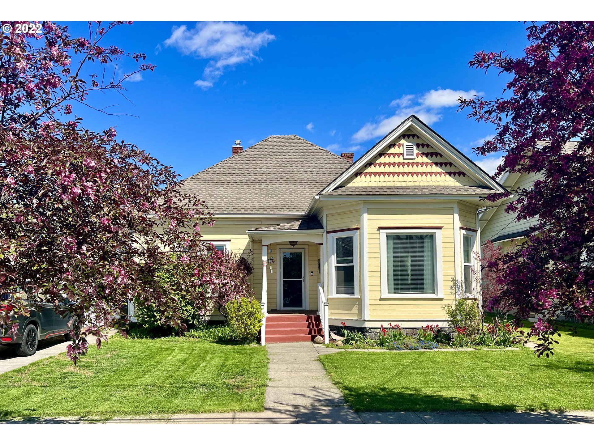 a front view of a house with a yard