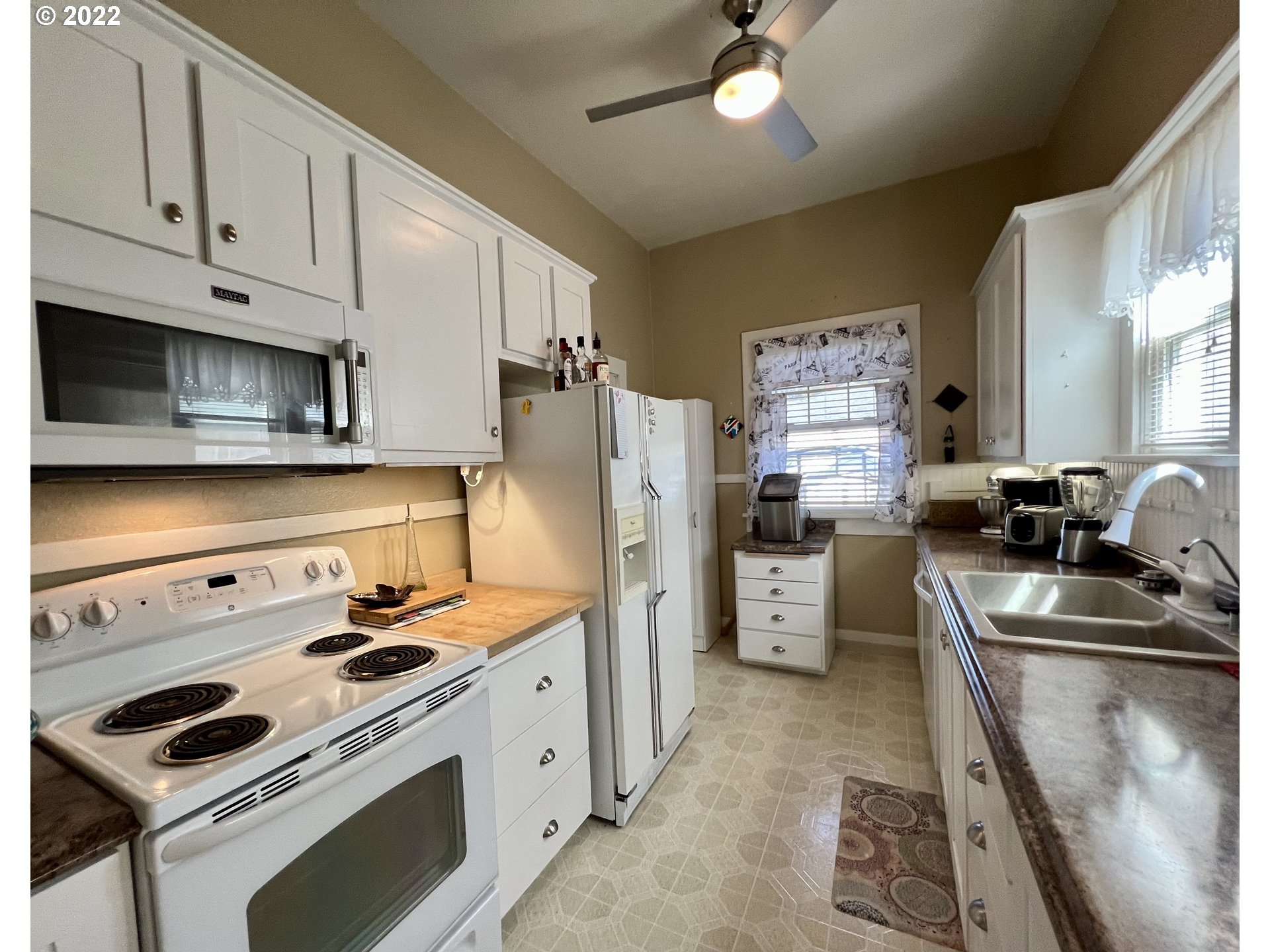 114 Southeast 7th Street Pendleton, OR 97801 - Photo 8 of 14 a kitchen with refrigerator stove and sink