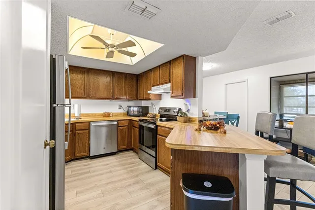 a kitchen with a sink a stove and cabinets
