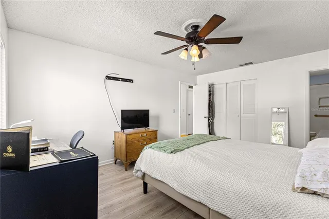 a bedroom with a bed and a desk