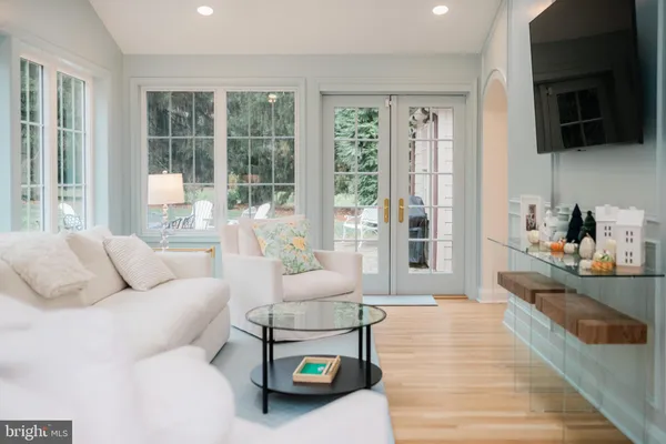 a living room with furniture and a floor to ceiling window