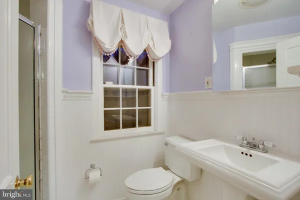 a bathroom with a sink toilet and mirror