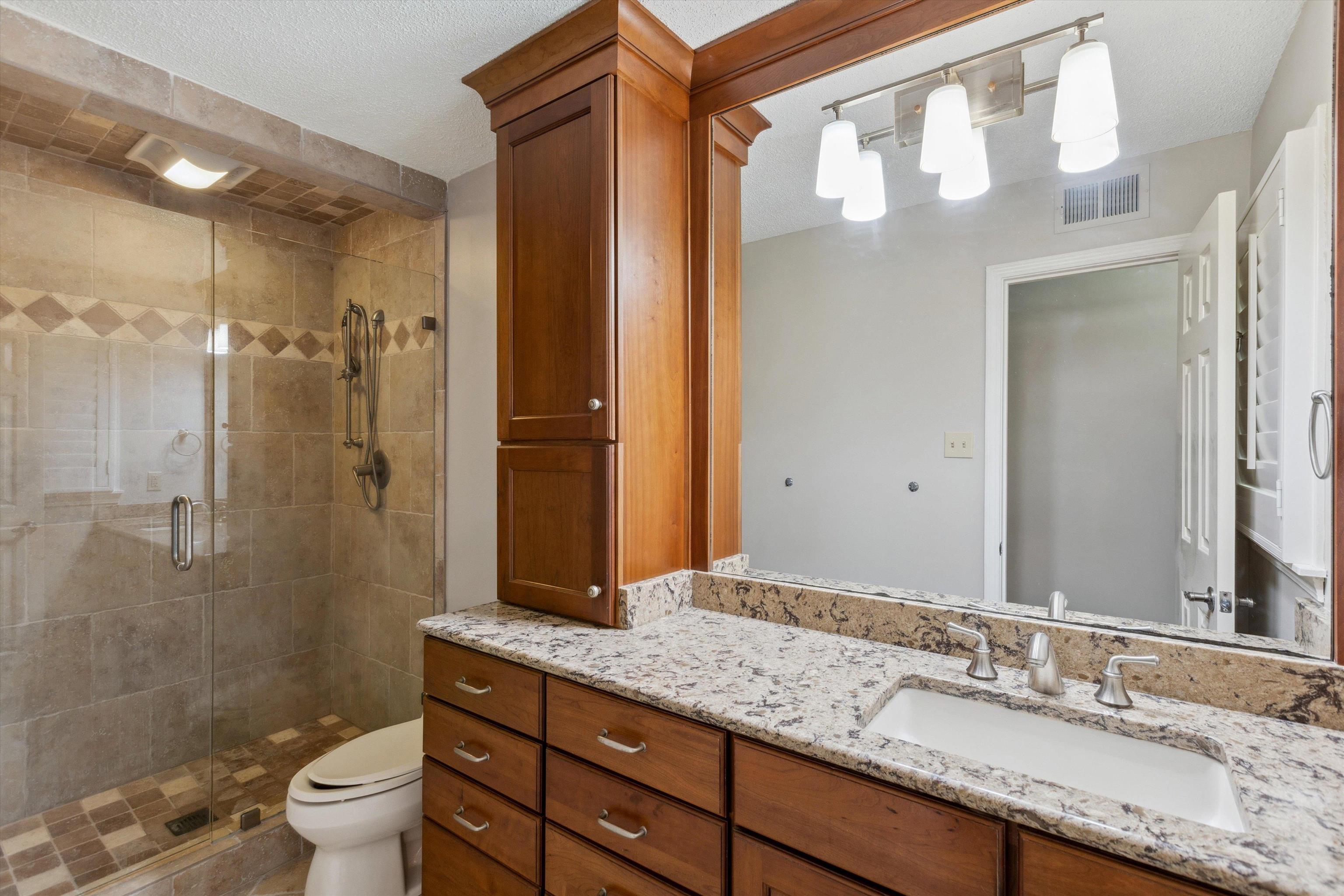 7617 Hollow Fork Road Germantown, TN 38138 - Photo 19 of 28 a bathroom with a granite countertop sink toilet and shower