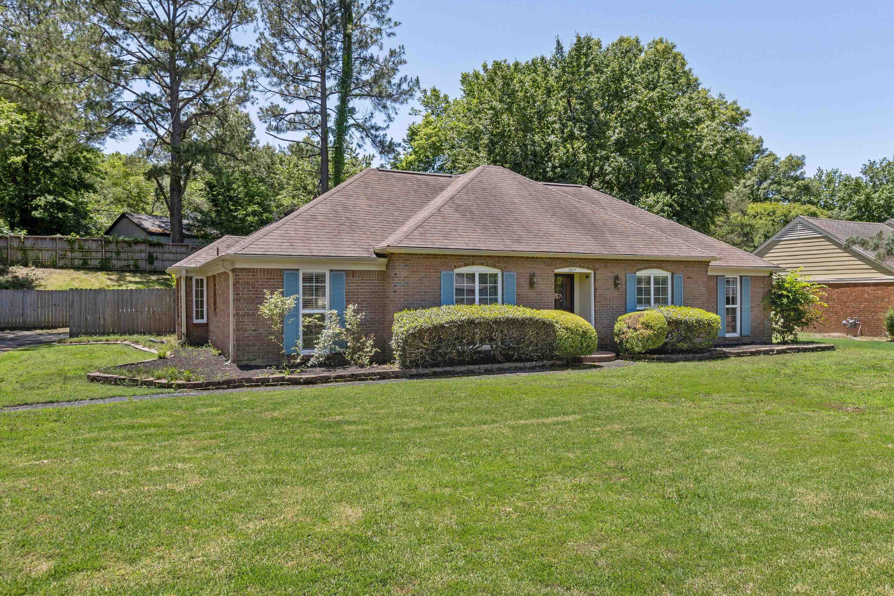7617 Hollow Fork Road Germantown, TN 38138 - Photo 2 of 28 a front view of a house with a garden