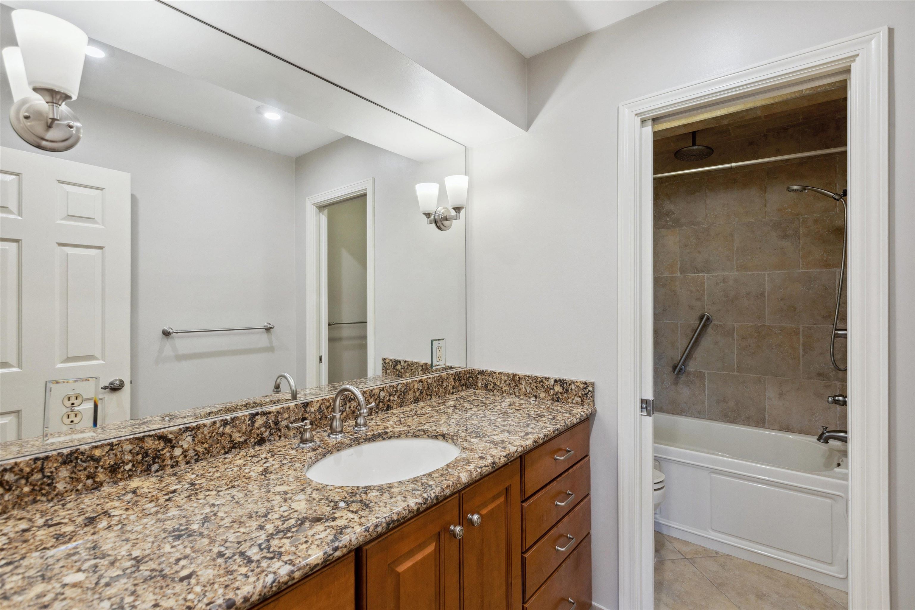 7617 Hollow Fork Road Germantown, TN 38138 - Photo 21 of 28 a bathroom with a granite countertop sink and a mirror