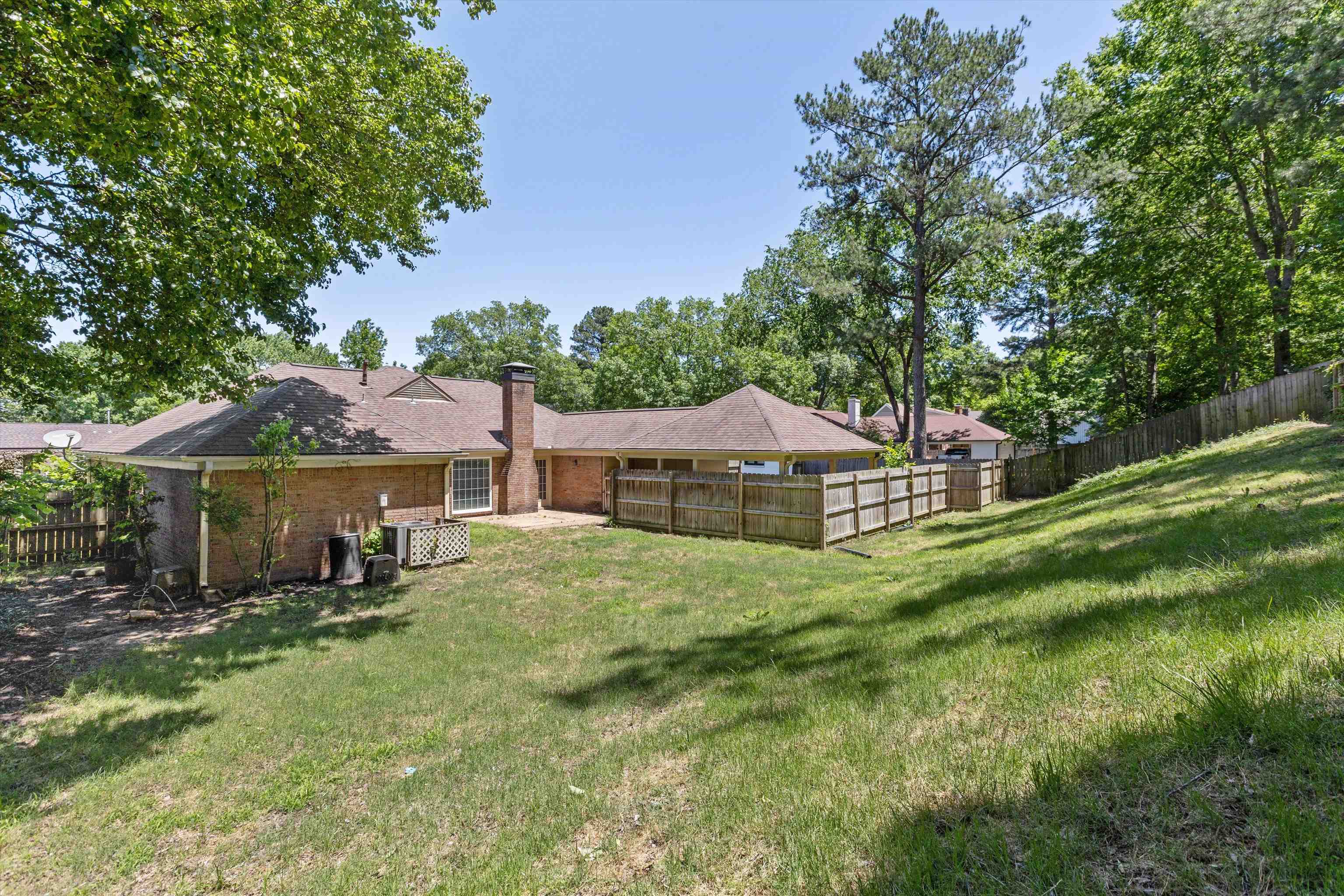 7617 Hollow Fork Road Germantown, TN 38138 - Photo 26 of 28 a front view of a house with a garden