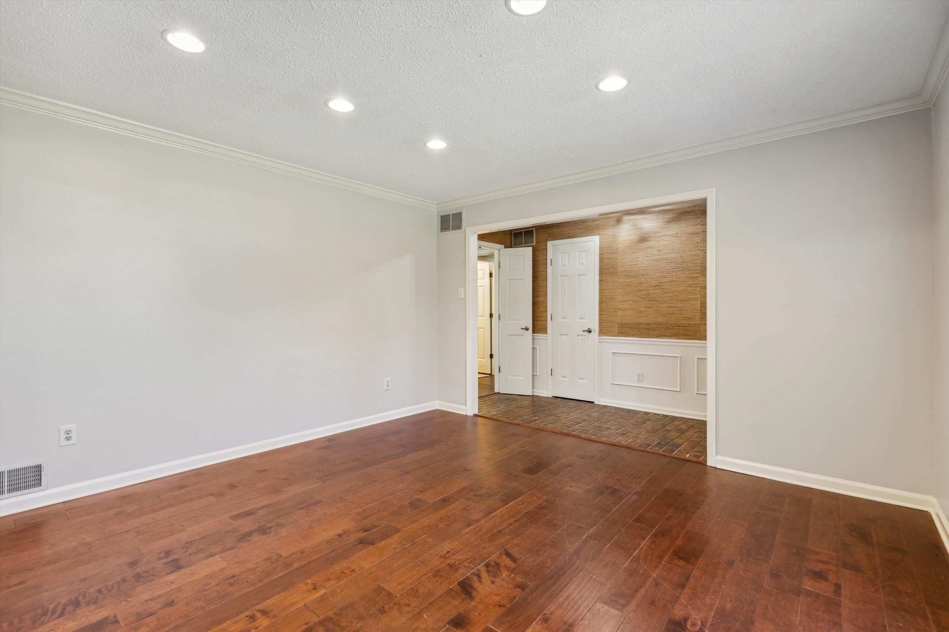 7617 Hollow Fork Road Germantown, TN 38138 - Photo 7 of 28 a view of an empty room with wooden floor and a window