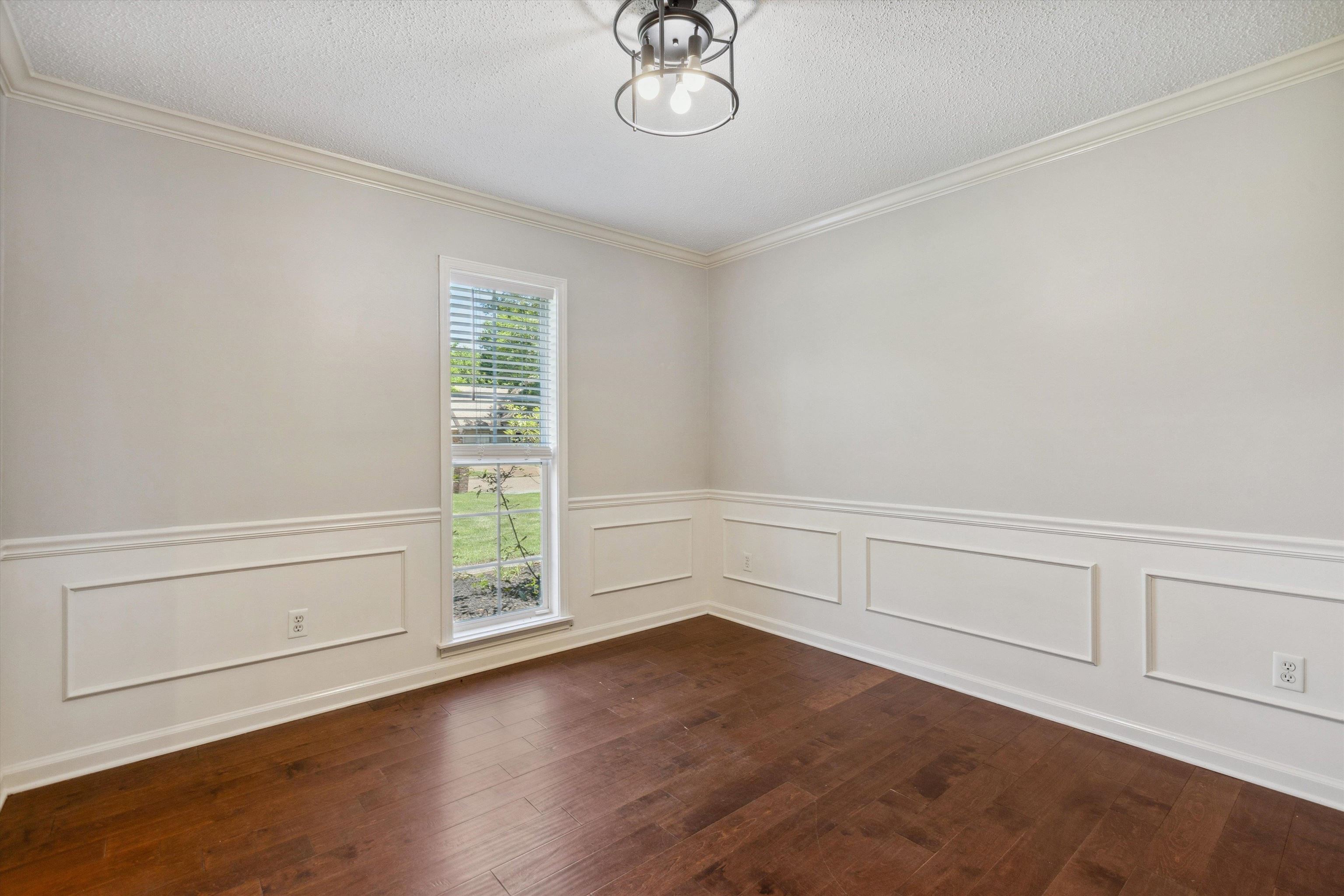 7617 Hollow Fork Road Germantown, TN 38138 - Photo 8 of 28 an empty room with wooden floor cabinet and windows