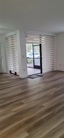 a view of wooden floor and windows in a room